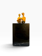 Load image into Gallery viewer, A modern art sculpture featuring two abstract figures in gold standing