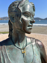 Load image into Gallery viewer, Bronze statue with a modern necklace against a clear blue sky