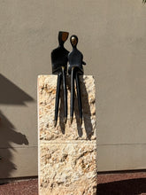 Load image into Gallery viewer, Abstract black metal sculpture of two seated figures
