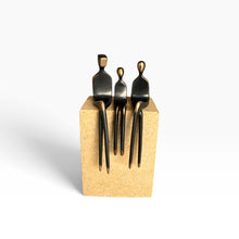 Load image into Gallery viewer, Three black metal utensils shaped like seated figures
