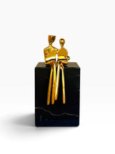 Load image into Gallery viewer, A small gold abstract sculpture of two seated figures 
