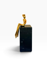 Load image into Gallery viewer, A gold pendant featuring
