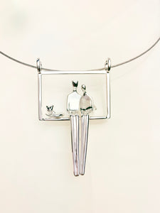 Couple with their cat pendant in silver.