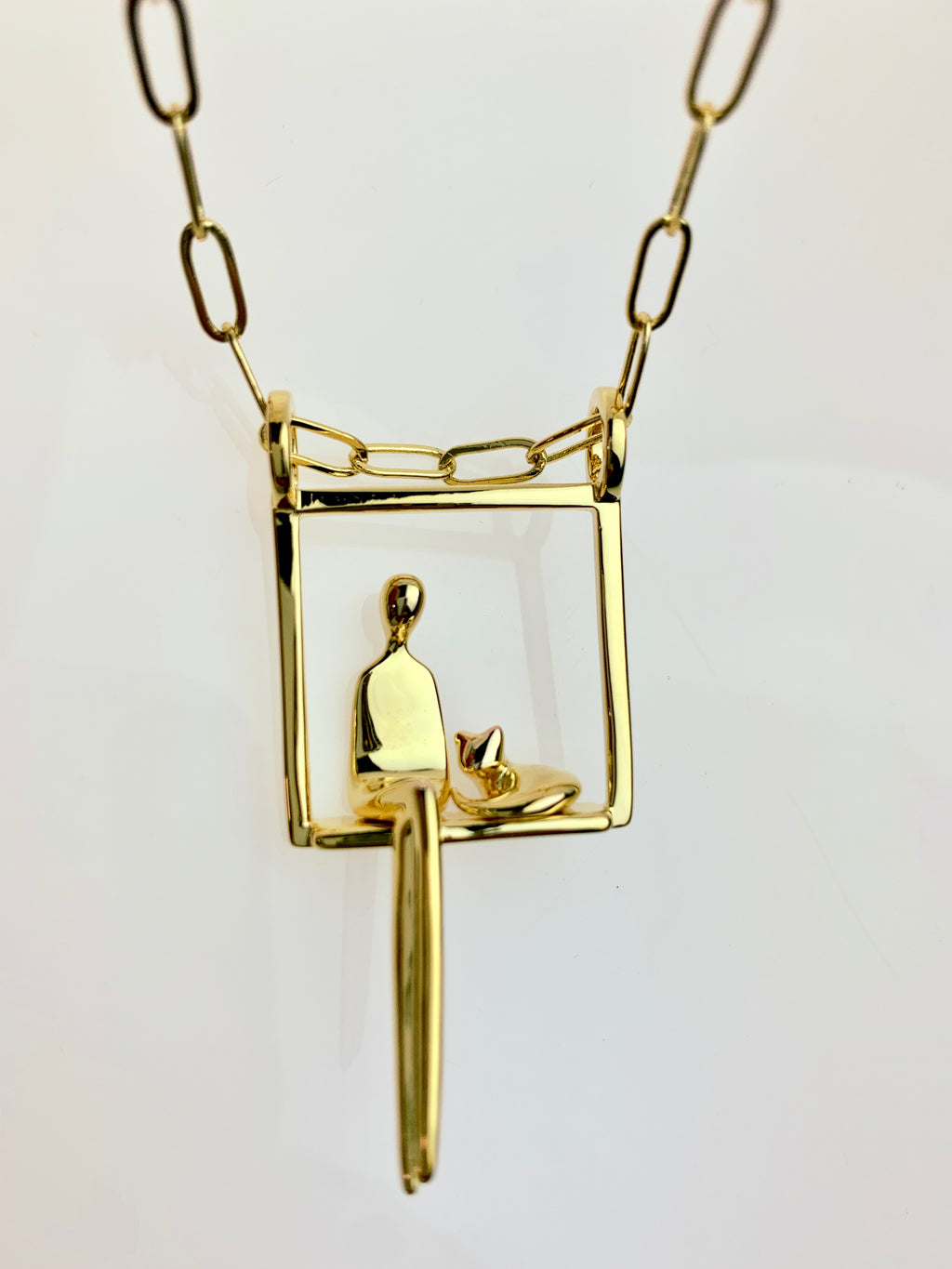 Woman with cat pendant in gold plated silver.